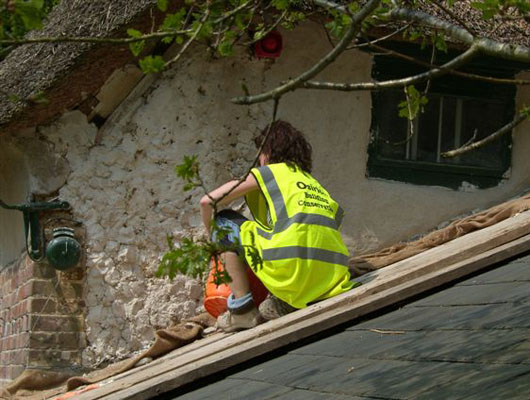 LIME RENDER: 'Pugging out' gable end in lime mortar prior to top coat